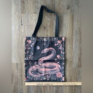 New in package, canvas type black snake tote book bag 15x13”